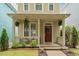 Welcoming covered front porch with hanging plants and a cozy seating area at 4605 All Points View Way, Raleigh, NC 27614