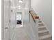 Bright hallway with carpeted stairs, a light wood railing, and bedrooms visible at the end of the hall at 4605 All Points View Way, Raleigh, NC 27614