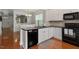 Updated kitchen with stainless steel appliances, black countertops, and white cabinets at 4605 All Points View Way, Raleigh, NC 27614