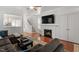Inviting living room featuring a fireplace and modern decor, with a view of the staircase at 4605 All Points View Way, Raleigh, NC 27614