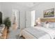 Bright main bedroom featuring light hardwood floors, an ensuite bathroom, and a decorative rug at 4605 All Points View Way, Raleigh, NC 27614