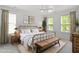 Well-lit bedroom features neutral color palette, ceiling fan, and ample natural light at 4605 All Points View Way, Raleigh, NC 27614