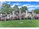 Green backyard and decks of townhomes on a sunny day with cloudy blue sky at 4658 Fawnbrook Cir, Raleigh, NC 27612