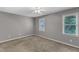 Neutral bedroom features carpet, two windows, and a ceiling fan at 4658 Fawnbrook Cir, Raleigh, NC 27612