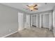 Bedroom featuring neutral carpet, a ceiling fan, and closet space at 4658 Fawnbrook Cir, Raleigh, NC 27612