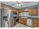 Functional kitchen with stainless steel appliances, wooden cabinets, and bright lighting at 4658 Fawnbrook Cir, Raleigh, NC 27612