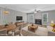 Furnished living room showcasing a fireplace, ceiling fan, and wood-look floors at 4658 Fawnbrook Cir, Raleigh, NC 27612