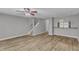 Open-concept living space with luxury vinyl plank flooring, a hanging light, and staircase at 4658 Fawnbrook Cir, Raleigh, NC 27612