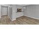 Bright, open-concept living room featuring a hanging light fixture and luxury vinyl plank flooring at 4658 Fawnbrook Cir, Raleigh, NC 27612
