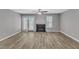 Light-filled living room featuring a ceiling fan, fireplace, and French doors to the backyard at 4658 Fawnbrook Cir, Raleigh, NC 27612