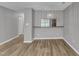 Living room with a hanging light fixture, luxury vinyl plank flooring, and light gray walls at 4658 Fawnbrook Cir, Raleigh, NC 27612