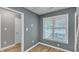 Neutral room with fresh paint, wood-look flooring and a bright, sunny window at 4658 Fawnbrook Cir, Raleigh, NC 27612