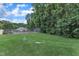 Well-maintained tennis court with a manicured lawn and privacy fencing at 4658 Fawnbrook Cir, Raleigh, NC 27612