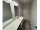 Bright bathroom featuring a white vanity with a modern sink, a large mirror, and a shower-tub combo at 48 Freedom Heights Ln # 150, Smithfield, NC 27577