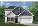 Charming two-story home featuring gray siding, a two-car garage, and a beautifully landscaped front yard at 48 Freedom Heights Ln # 150, Smithfield, NC 27577