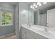 Bathroom featuring double sinks, granite countertops, and well-lit mirror, offering modern amenities at 5 Providence Ridge Ln, Durham, NC 27713