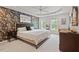 Relaxing bedroom with decorative wallpaper accent wall, tray ceiling, and bright natural light at 5 Providence Ridge Ln, Durham, NC 27713