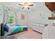 Bright bedroom with colorful bedding, complemented by a ceiling fan and ample natural light at 5 Providence Ridge Ln, Durham, NC 27713