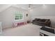 Spacious bonus room with plush seating, offering versatile living space and natural light at 5 Providence Ridge Ln, Durham, NC 27713