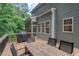 View of deck, gray siding, outdoor table, and grill of this charming home at 5 Providence Ridge Ln, Durham, NC 27713