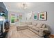 Bright living room with a comfortable sectional sofa, hardwood floors, and a fireplace at 5 Providence Ridge Ln, Durham, NC 27713
