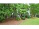 Backyard view of the house. Mature trees surround the perimeter at 516 Ryan Rd, Cary, NC 27511