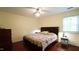 This is a large bedroom with a ceiling fan and a dark wood bedframe set on a darkwood floor at 516 Ryan Rd, Cary, NC 27511