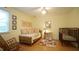 Bright bedroom with a crib and daybed and three framed pictures on the wall at 516 Ryan Rd, Cary, NC 27511
