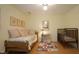 Bright bedroom with a crib and daybed and three framed pictures on the wall at 516 Ryan Rd, Cary, NC 27511