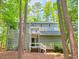 Charming two-story home featuring a covered entryway, set amidst a lush green forest landscape at 516 Ryan Rd, Cary, NC 27511