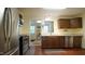Efficient kitchen space featuring stainless steel appliances and a bright view to an adjacent room at 516 Ryan Rd, Cary, NC 27511