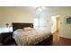 Main bedroom with a comfortable bed and adjacent entryways to other rooms at 516 Ryan Rd, Cary, NC 27511
