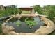 Picturesque pond and stone patio area in a beautiful park setting at 516 Ryan Rd, Cary, NC 27511