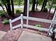 Brick patio with white railings and decorative potted plants, providing a charming outdoor area at 516 Ryan Rd, Cary, NC 27511
