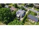 An aerial view of a two-story home with a beautiful roof and a driveway surrounded by trees at 523 Vick Ave, Raleigh, NC 27612