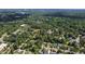 An overhead view of a neighborhood showcasing lush foliage, well-maintained homes, and paved roads at 523 Vick Ave, Raleigh, NC 27612