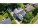 An aerial view of a two-story home with an attached garage and a driveway surrounded by lush greenery at 523 Vick Ave, Raleigh, NC 27612