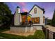 Inviting backyard has a spacious deck, stylish lighting, and beautiful landscaping, ideal for outdoor living and entertaining at 523 Vick Ave, Raleigh, NC 27612