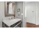 Bathroom featuring a marble vanity, chrome fixtures, and a well-lit space with neutral tones at 523 Vick Ave, Raleigh, NC 27612