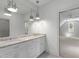 Bright bathroom with double vanity, granite countertop, and modern lighting fixtures at 523 Vick Ave, Raleigh, NC 27612