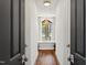 Bathroom showcasing a soaking tub beneath a window and chandelier, framed by double doors for privacy at 523 Vick Ave, Raleigh, NC 27612