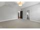 Spacious bedroom with neutral carpet, multiple doorways, and a decorative ceiling light at 523 Vick Ave, Raleigh, NC 27612