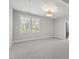 Bright bedroom with neutral tones, large window and simple light fixture, creating a serene space at 523 Vick Ave, Raleigh, NC 27612