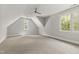 Spacious bedroom with carpet, a ceiling fan, and large windows at 523 Vick Ave, Raleigh, NC 27612