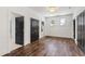 Spacious bedroom featuring hardwood floors, black doors, natural light from large windows at 523 Vick Ave, Raleigh, NC 27612