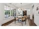 Charming dining room with large windows, stylish lighting, and seating for four around a round table at 523 Vick Ave, Raleigh, NC 27612
