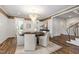 Bright dining room featuring a chandelier, hardwood floors, and a decorative rug under the table at 523 Vick Ave, Raleigh, NC 27612