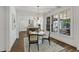 Sunlit dining room showcasing a modern chandelier, hardwood floors, and views into the bright kitchen at 523 Vick Ave, Raleigh, NC 27612