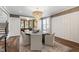 Bright dining room featuring a chandelier, hardwood floors, and a decorative rug under the table at 523 Vick Ave, Raleigh, NC 27612