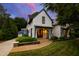 Stunning two-story home with a manicured lawn, stone pathway, shake siding and a detached two-car garage at 523 Vick Ave, Raleigh, NC 27612